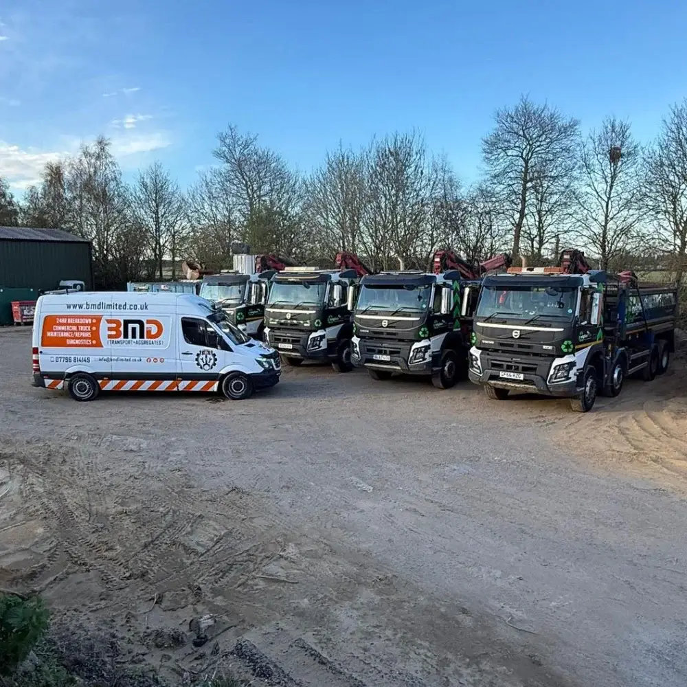 BMD Transport fleet of tipper lorries and service van parked at depot yard