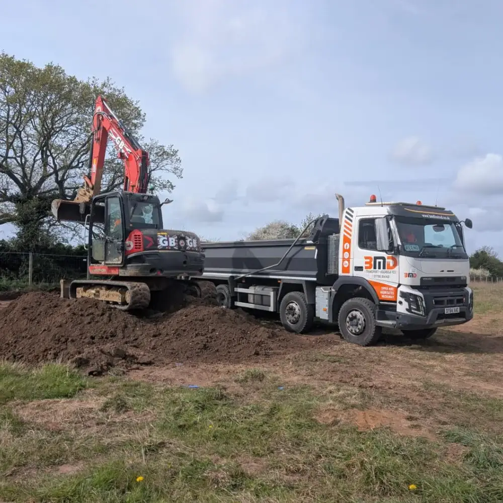 BMD Transport and Aggregates grab lorry being loaded by excavator on a construction site in Norfolk