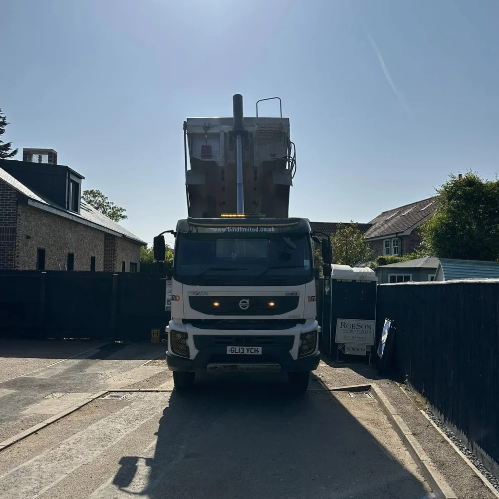 BMD tipper lorry delivering materials to a residential site